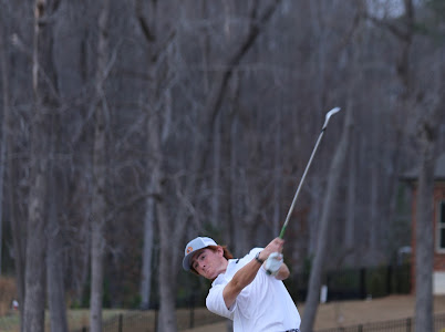Junior, Daniel Boone hits a shot during a practice round.