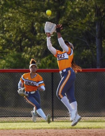 Fuquay softball player Kendall Smith, junior, makes a defensive play on the ball while Ayala Durant, freshman, prepares to back Smith up during the teams regular season. The team advanced to the fourth round of the State playoffs, losing to D.H. Conley. 
