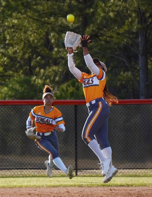 Fuquay softball player Kendall Smith, junior, makes a defensive play on the ball while Ayala Durant, freshman, prepares to back Smith up during the teams regular season. The team advanced to the fourth round of the State playoffs, losing to D.H. Conley. 