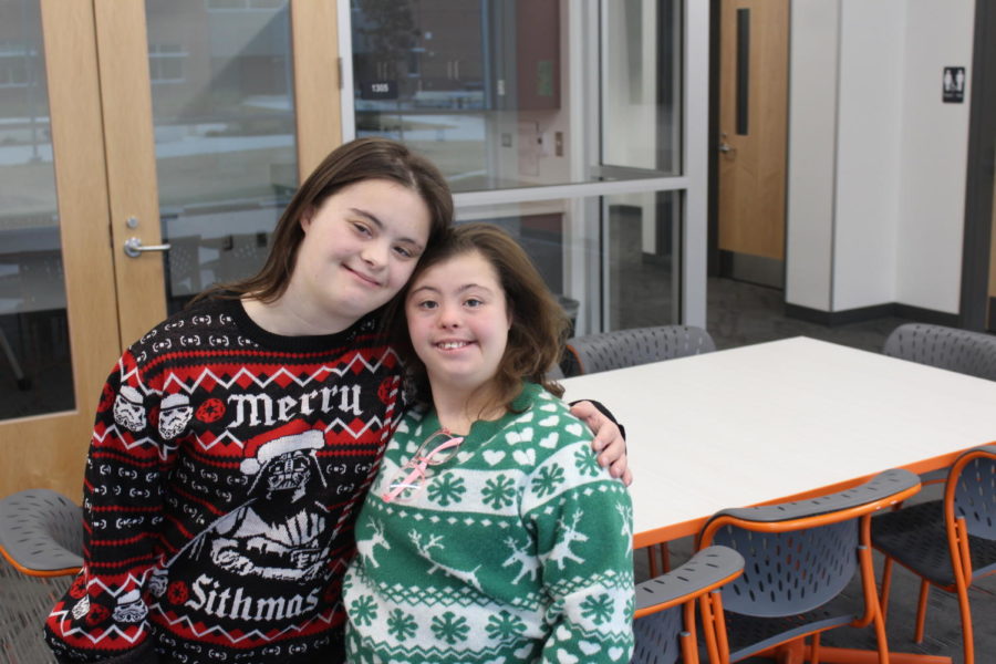 Mia Mancini and Emily McWhirter show their Christmas spirit with festive holiday sweaters