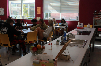 Students listen in class as they learn about food and cooking.