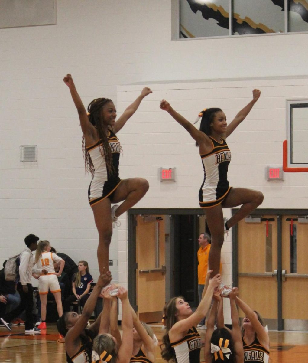 Fuquay Varina High School varsity cheerleaders perform a double liberty at a recent basketball game.