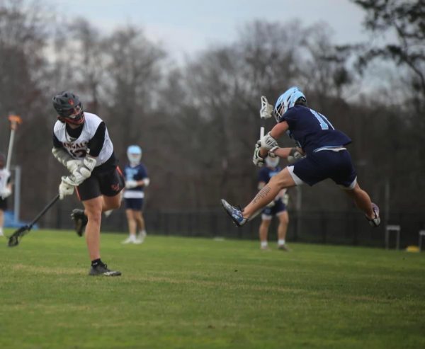 Junior Connor Everett takes a shot on the Cleveland goal during the varsity lacrosse game.
