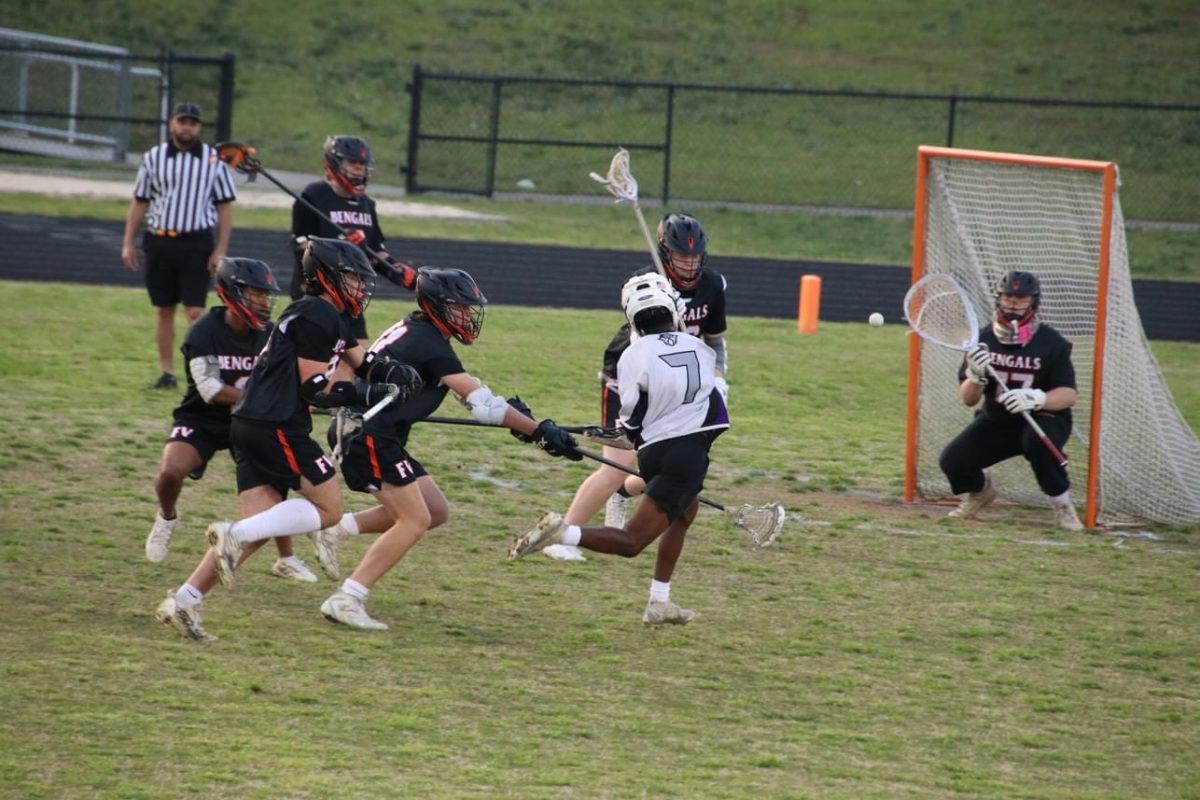 A South Garner player takes an unsuccessful shot on junior goalie Ben Thrift. Fuquay-Varina went on to win the game 20-8.