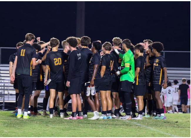 The men’s soccer team in a huddle before the game