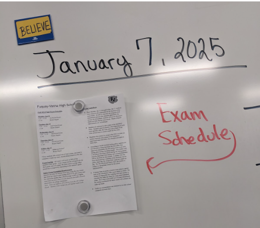 English Teacher Cara Williams puts up the exam schedule for her students.