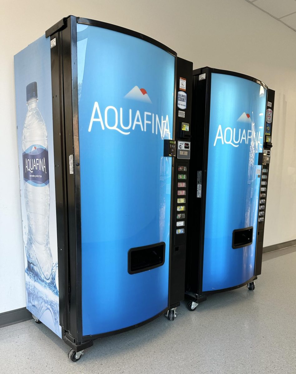 The two Aquafina vending machines just outside the cafeteria in operation for students.

