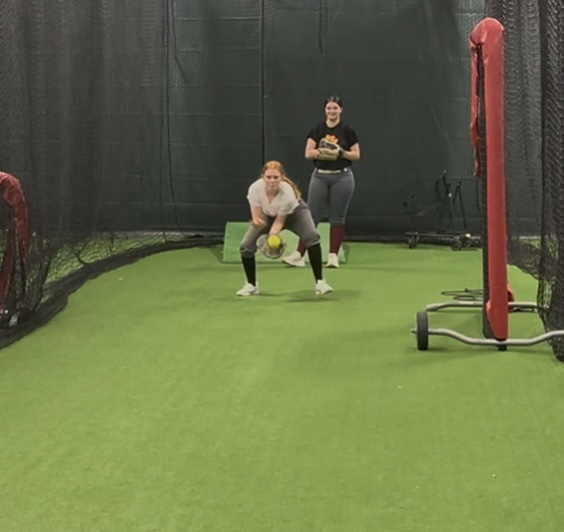 Junior Kylie McGrogan and sophomore Kyleigh Pickard working hard for softball tryouts.

