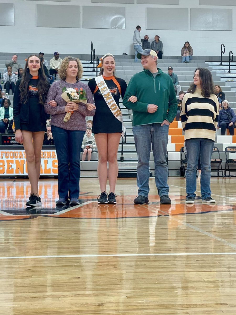 Senior Ava Mitchell celebrates with her family on Senior Night.

