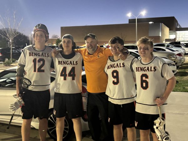 Fuquay-Varina Bengals lacrosse beat Swansboro 14-6 last friday night. Senior Connor Everette, junior Nadeem Elazzy, Coach Brad Wheeler, senior Jake Macintyre, and senior Connor Castle celebrated after the win. 

