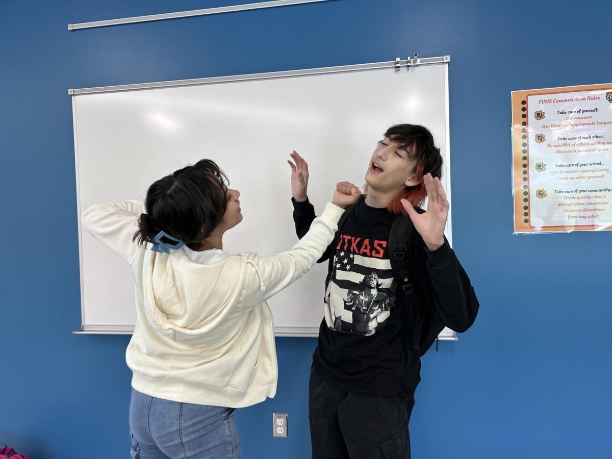 Kiki Quinteros demonstrates the type of relationships that are often depicted in reality tv causing Eli Crosby to throw their hands up in defense.