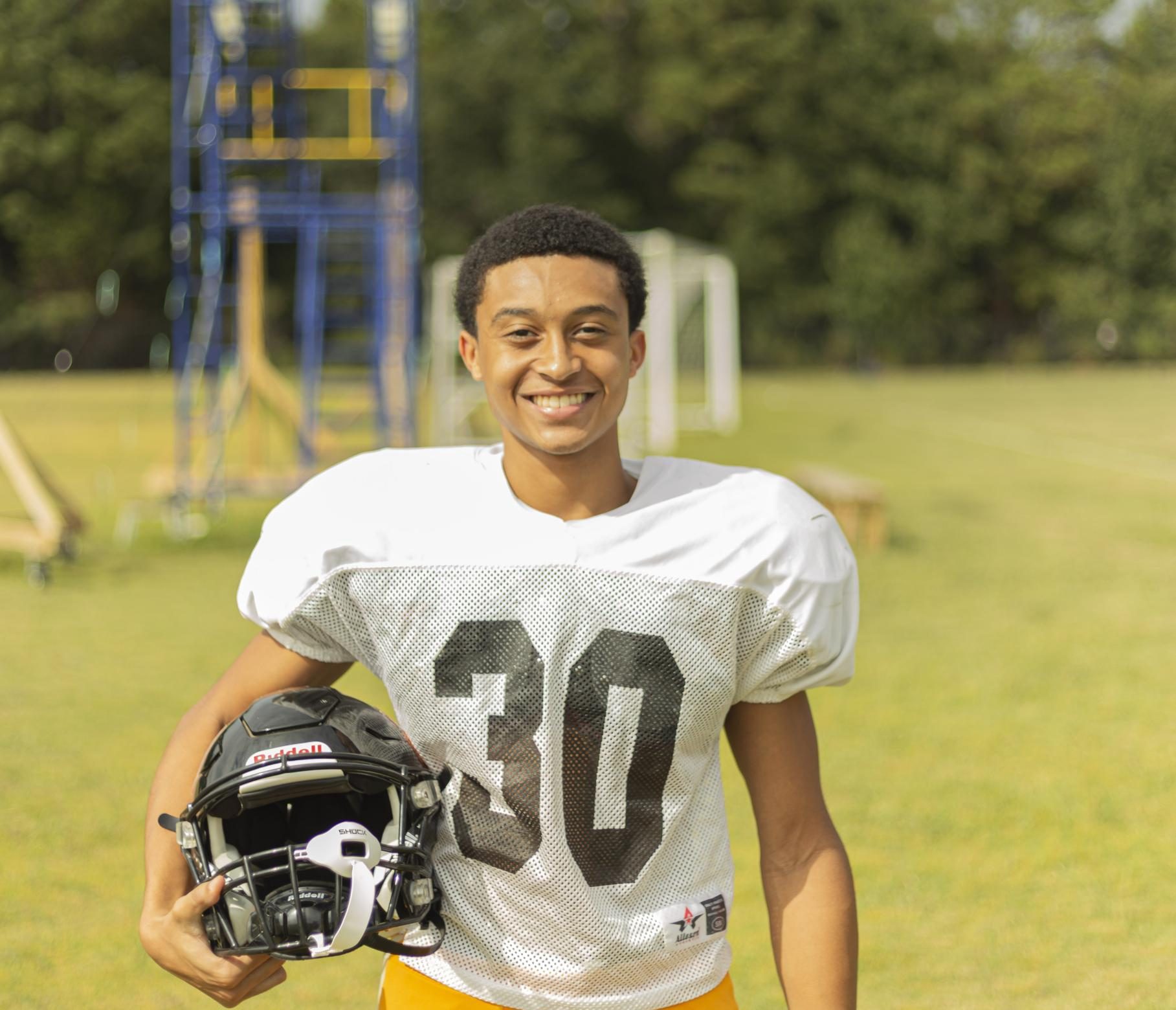 Junior Justin Odom showcases his freshly shined helmet before practice. 