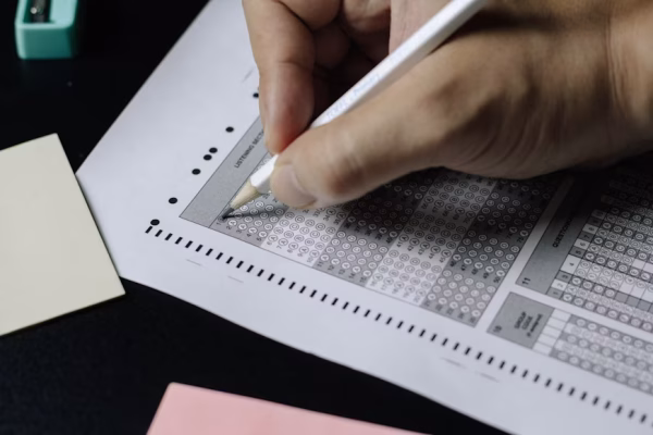 Person fills out a multiple choice test.