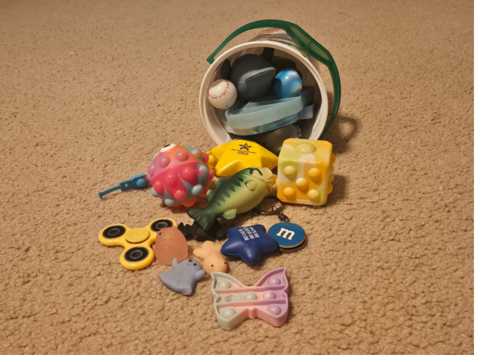 A collection of fidget toys spills out of a bucket.