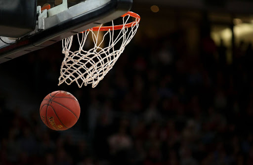 Basketball goes through the net.  