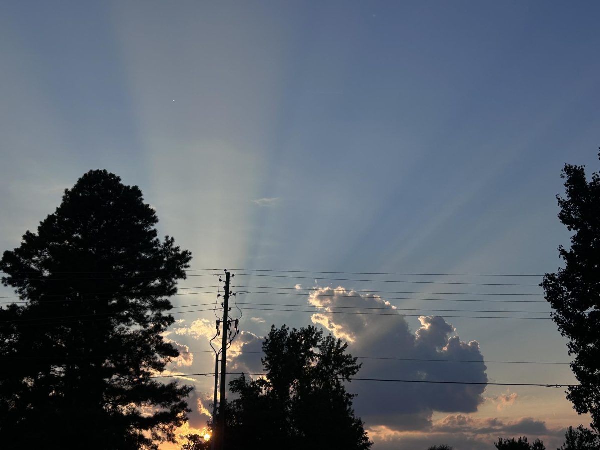 The sun casts rays of light through the clouds on another day without a Biblical disaster.