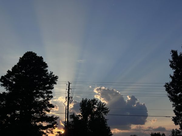 The sun casts rays of light through the clouds on another day without a Biblical disaster.