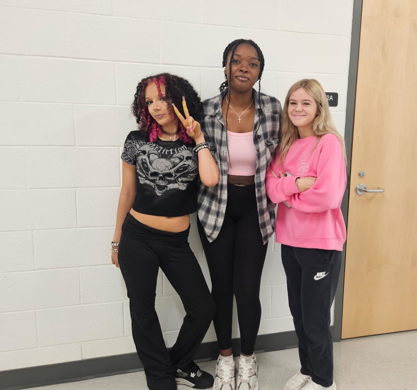 Jaleah Lucas, Olyvia Mcdougald, and Reese Barton pose in their pink for spirit week.