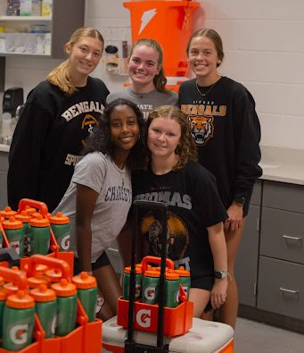 Sports trainers prepping for games in the training room.