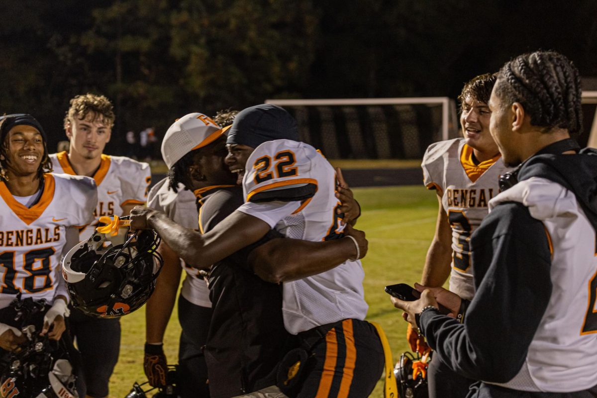 Varsity football’s season ended this week with a loss in round two of the state playoffs. One of the highlights of the season was a victory in round one over rivals Holly Springs. Junior Jordan McNeil celebrated with coach Marcellus Simmons and the team afterwards.