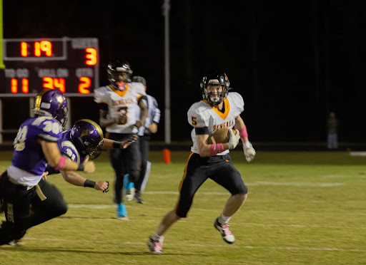 Senior Corbin Peacock runs the ball in the Bengals’ victory versus Holly Springs High School. 