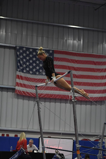 Senior Pyper Penland competes on the bars for her team to win the state title. She scored a 9.6/10. Photo taken by Aiden Royall