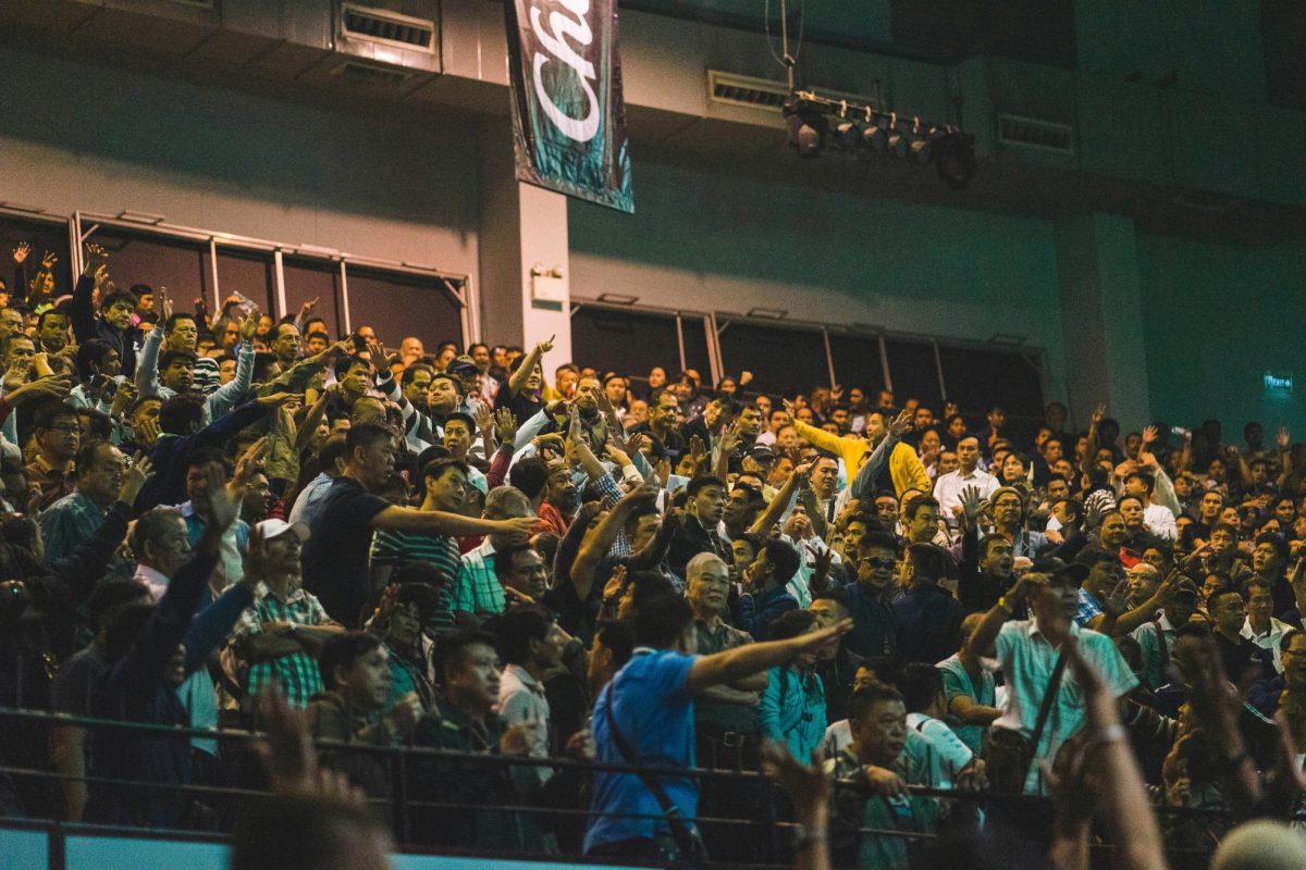 Crowds of people with bets celebrating their wins.