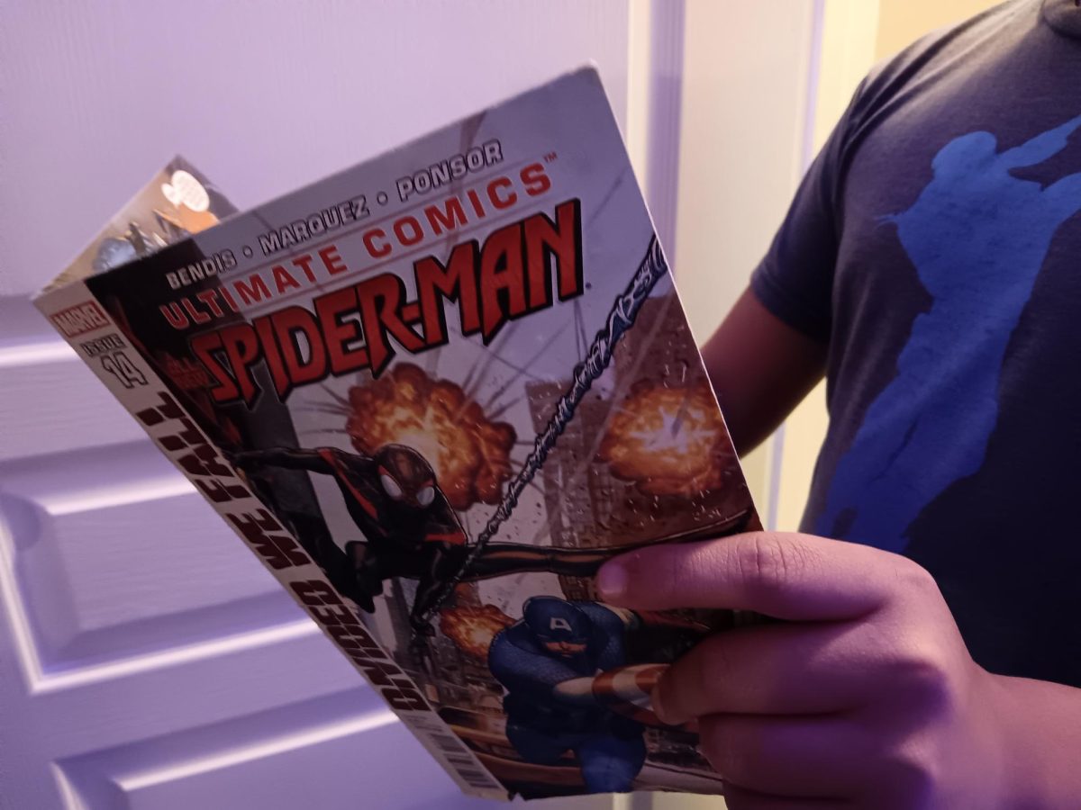 Someone choosing to read a Marvel comic book.