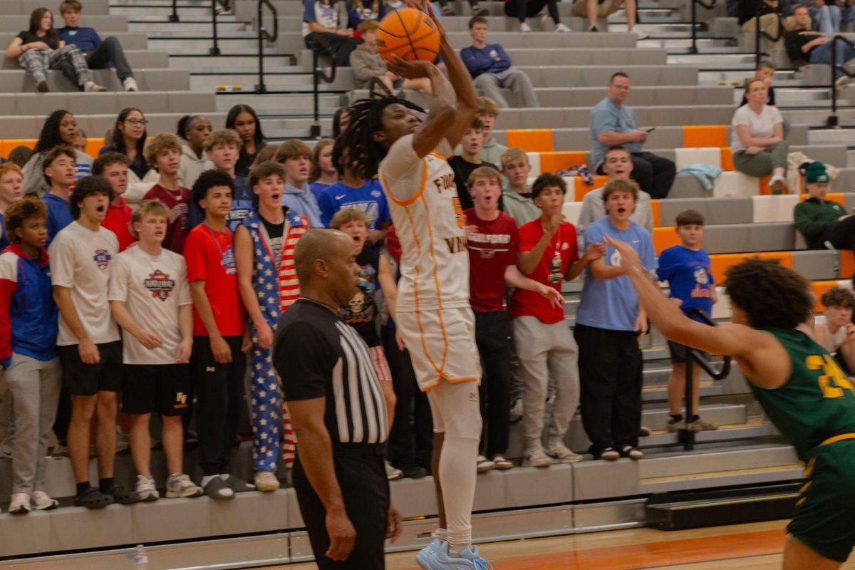 Senior Abdou Diop attempts a three point shot against Apex.