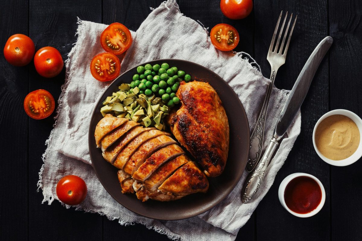 Chicken can be prepared and eaten in many different ways, one of these ways being roasted and cooked with vegetables. Photo by Elena Leya on Unsplash.