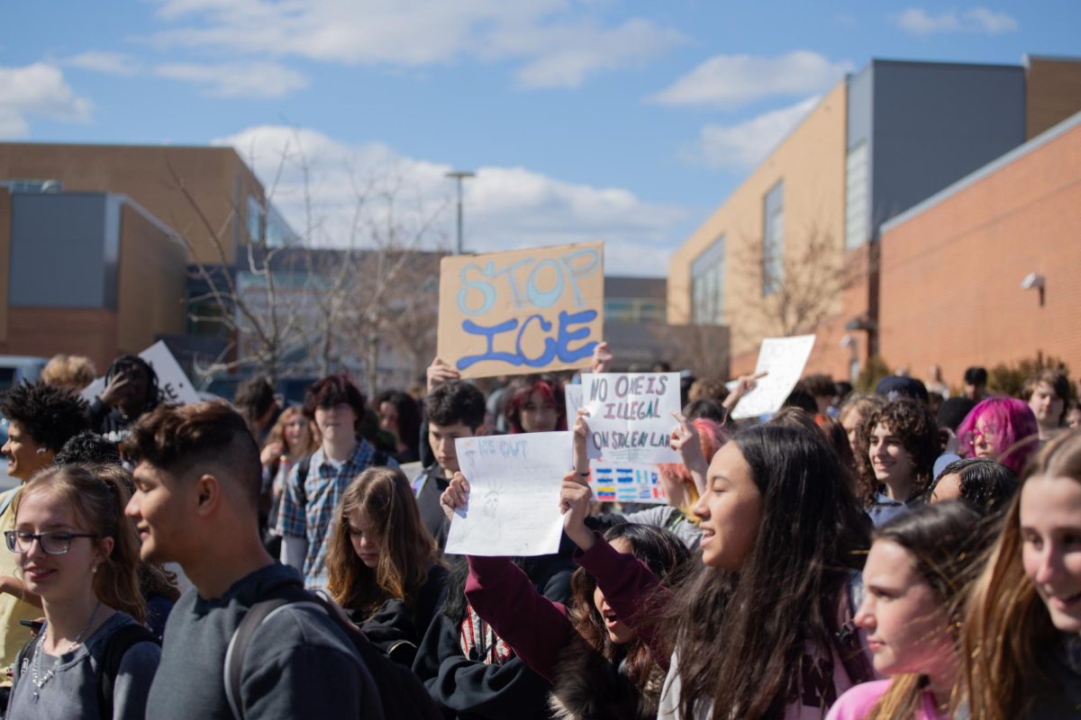 Students walk together with signs for protest