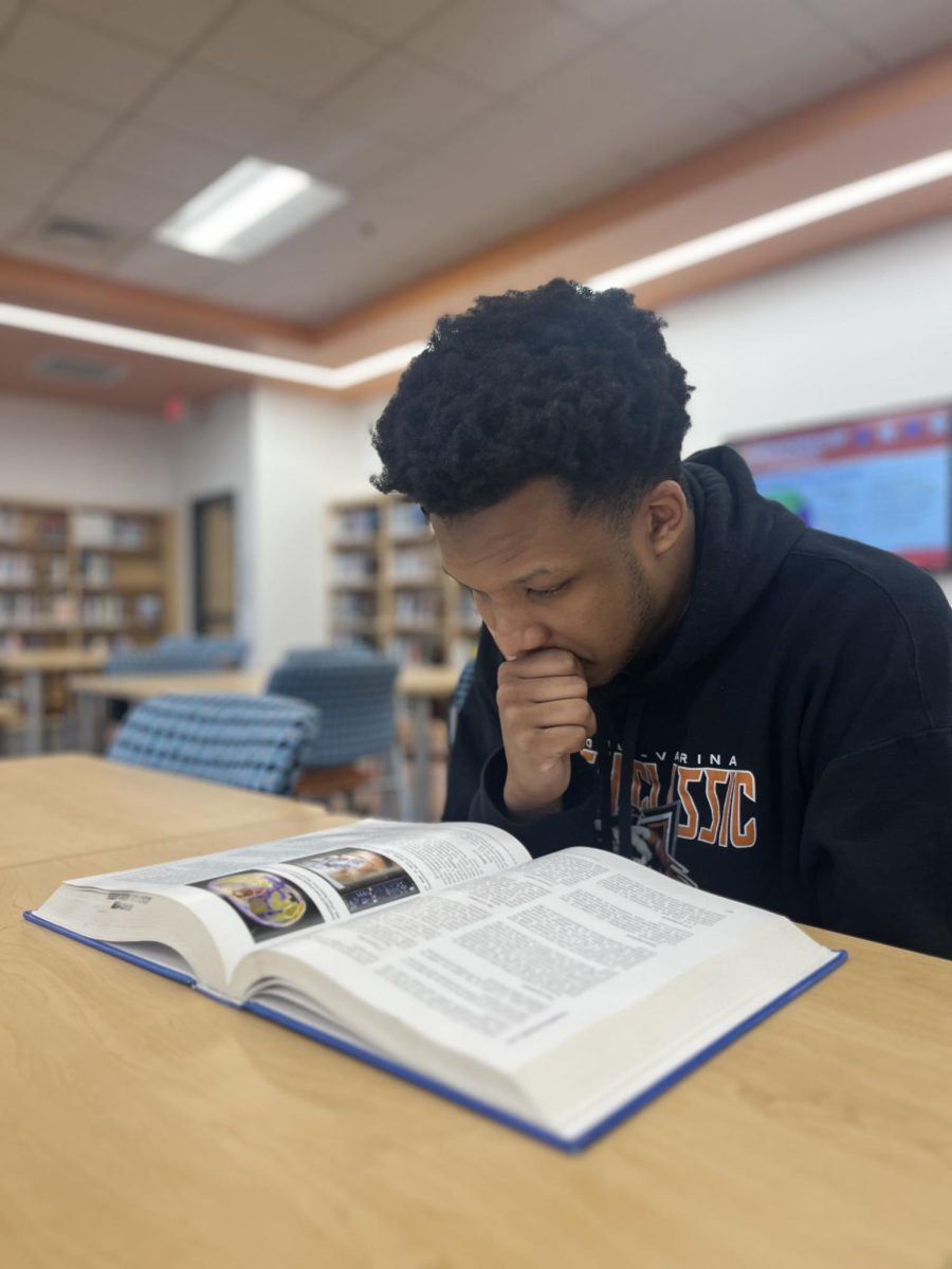 Senior Jamie Jordan takes advantage of a quiet moment to read in the Media Center. 