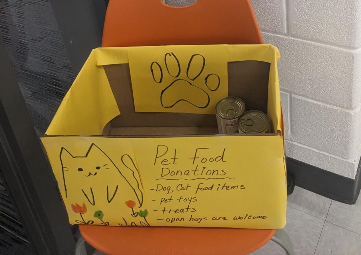 Posters made by students are around the school encouraging people to donate food to animal shelters.