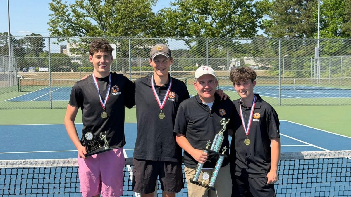 Junior Holden de Vente, senior Porter Reese, head coach Marshall Wortham and junior Colton Mendler all took home hardware after the GNRC tournament. Photo courtesy of Jessica Reese