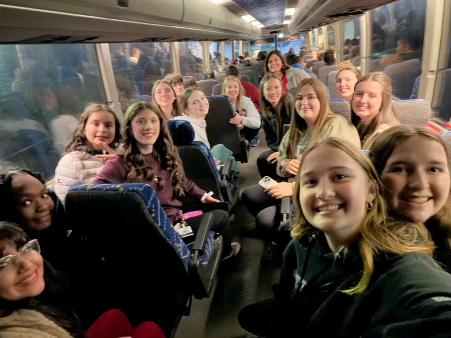 Students ride the bus to get to Greensboro for the conference.