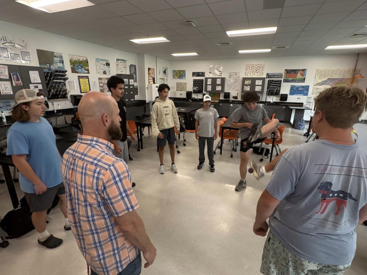 Freshmen Travis Mayer, James Connor, Aiden Ginsburg, Gavin Leveille, Jackson Nakazono, Nate Gardner, Michael McGahey and teacher David St. Clair enjoy a game of hacky sack during a break in Earth Science.