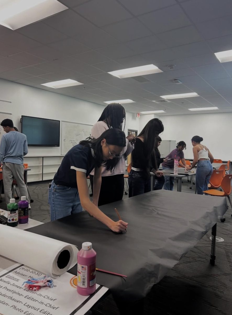 Student Council members work together to prepare decorations and materials for the upcoming senior sunset.